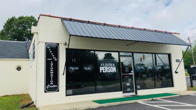 The front of Person County Tourism visitor center in a white brick building